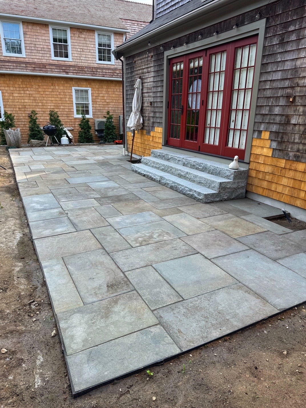 Patio with granite steps and red door